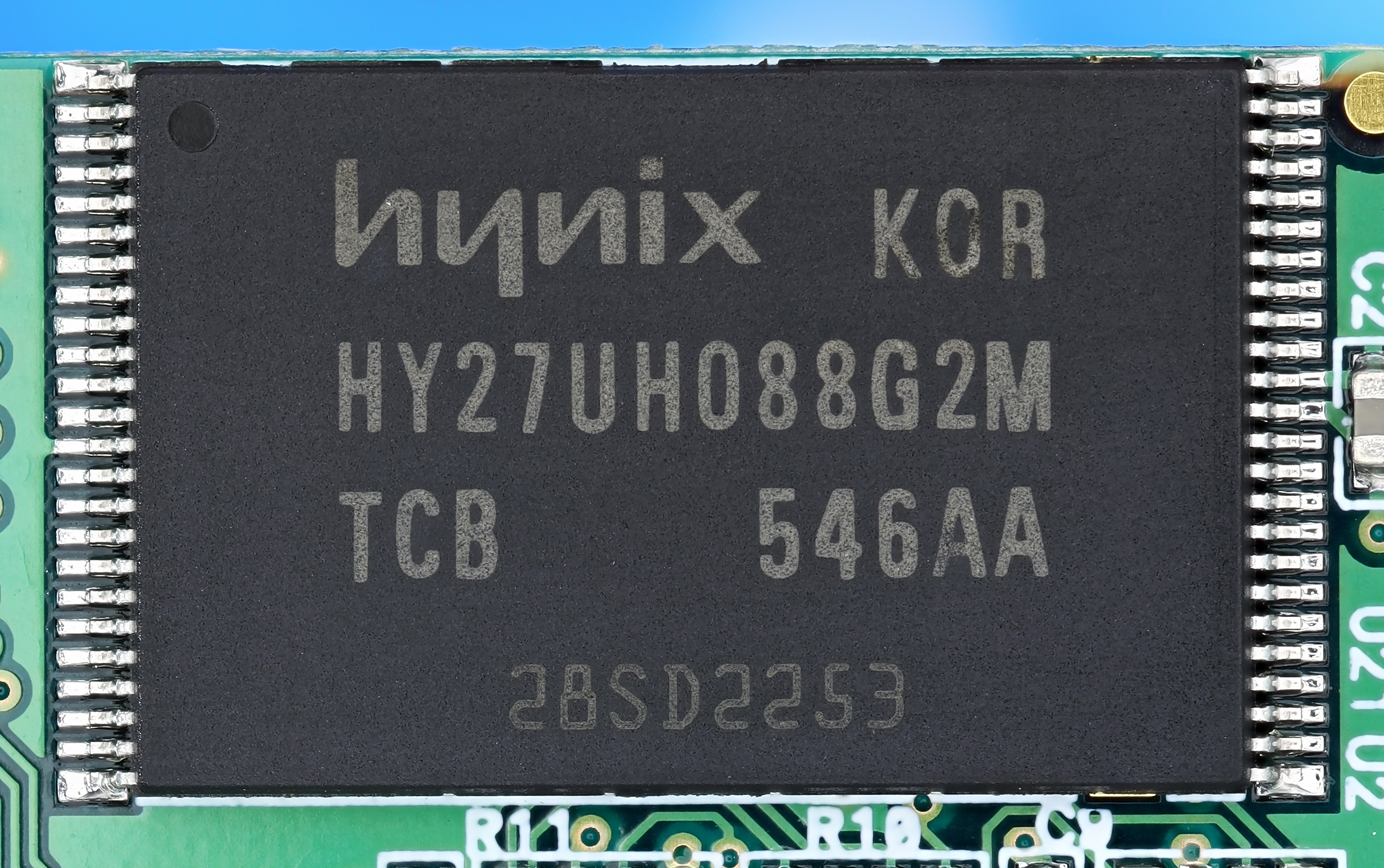 Close-up photograph of a Hynix HY27UH088G2M 8-gigabit NAND flash memory chip in a TSOP-48 surface-mount package. The chip is rectangular with 24 pins along each long edge, the manufacturer markings printed on the top of the package, and visible solder pads showing where it would attach to a PCB. Chips of this physical form factor were the standard target of feature-phone era chip-off acquisition, removed from the board and read in a TSOP-48 socket adapter.
